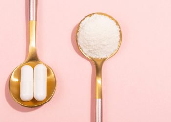 Collagen powder and pills on pink background. Extra protein intake. Natural beauty and health supplement for skin, bones, joints and gut. Plant or fish based. Flatlay, top view.